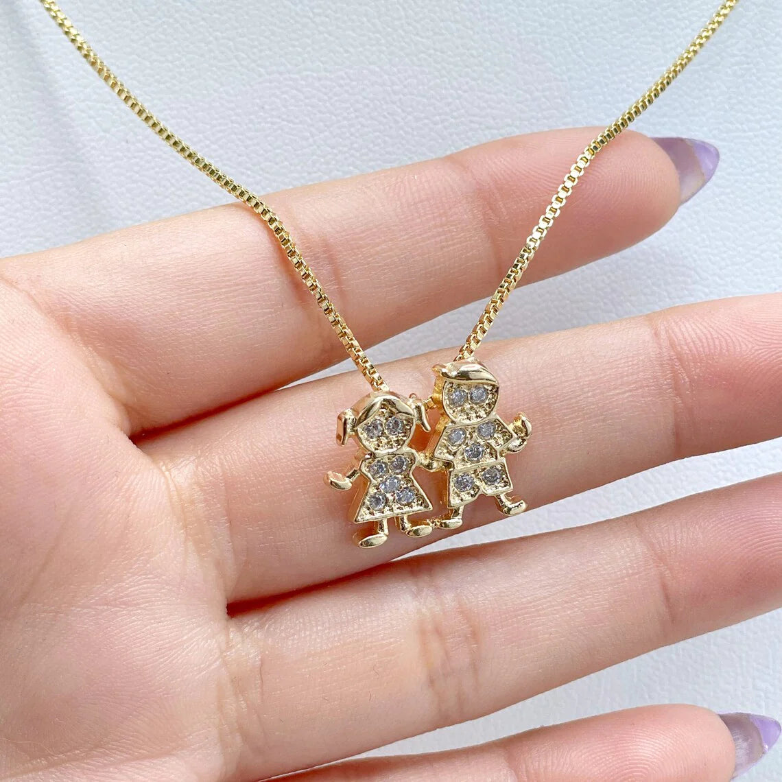 Chain and Pendant Set. Box Link Chain with Boy and Girl Pendant in Cubic Zirconia 18k Gold Filled. Bundle and Save. FREE SHIPPING on orders of $100 and over.  Sam's Jewelry World USA.