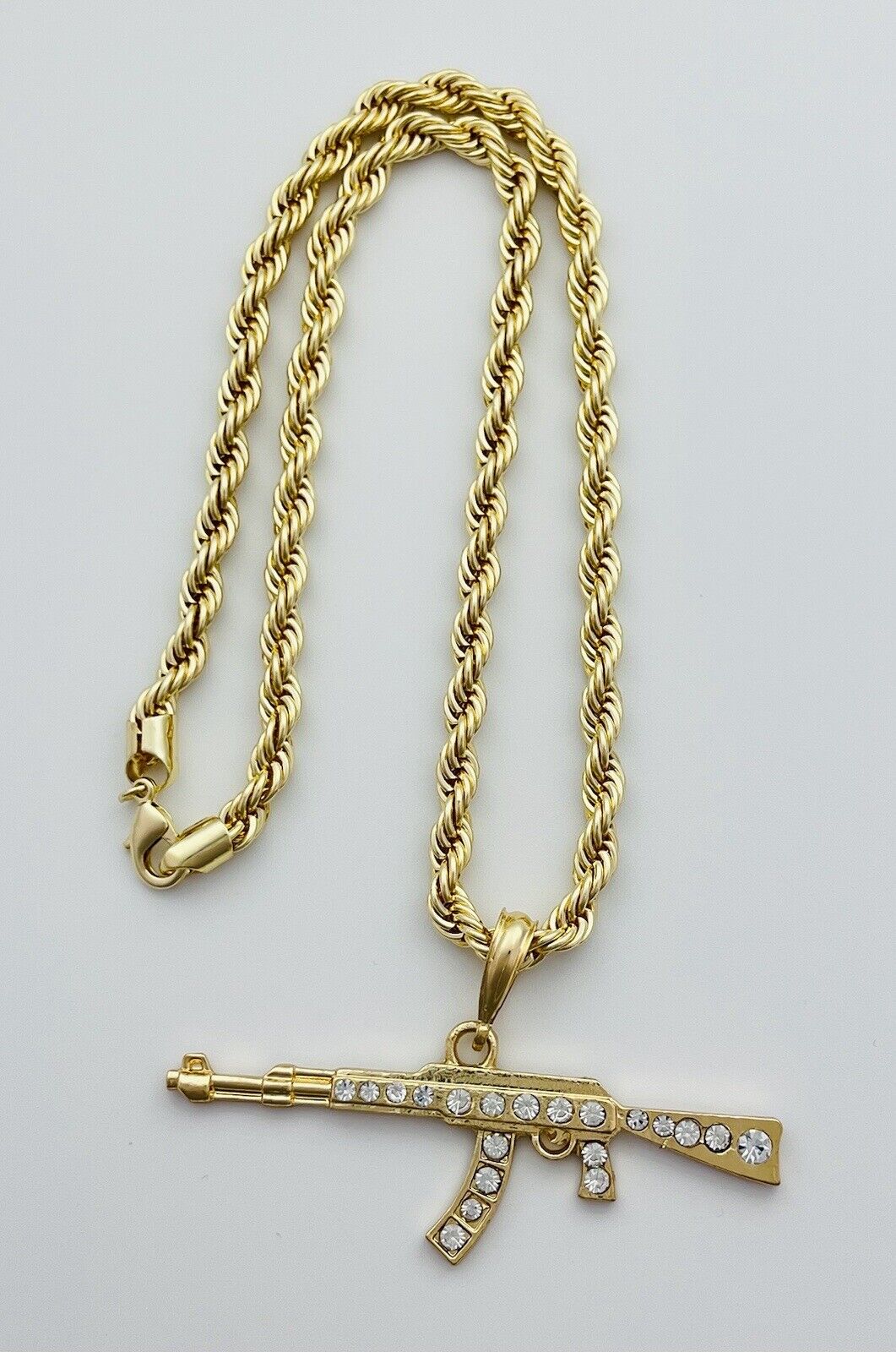 Chain and Pendant Set. Firearm and 6mm Rope Chain Set 18k Gold Filled. Bundle and Save. FREE SHIPPING on orders of $100 and over.  Sam's Jewelry World USA.